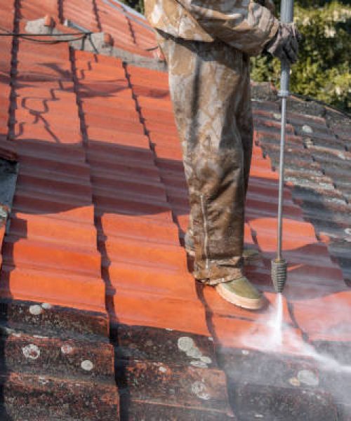 State of roof before and after washing with high pressure. Professional is wearing uniform and using equipment for cleaning.